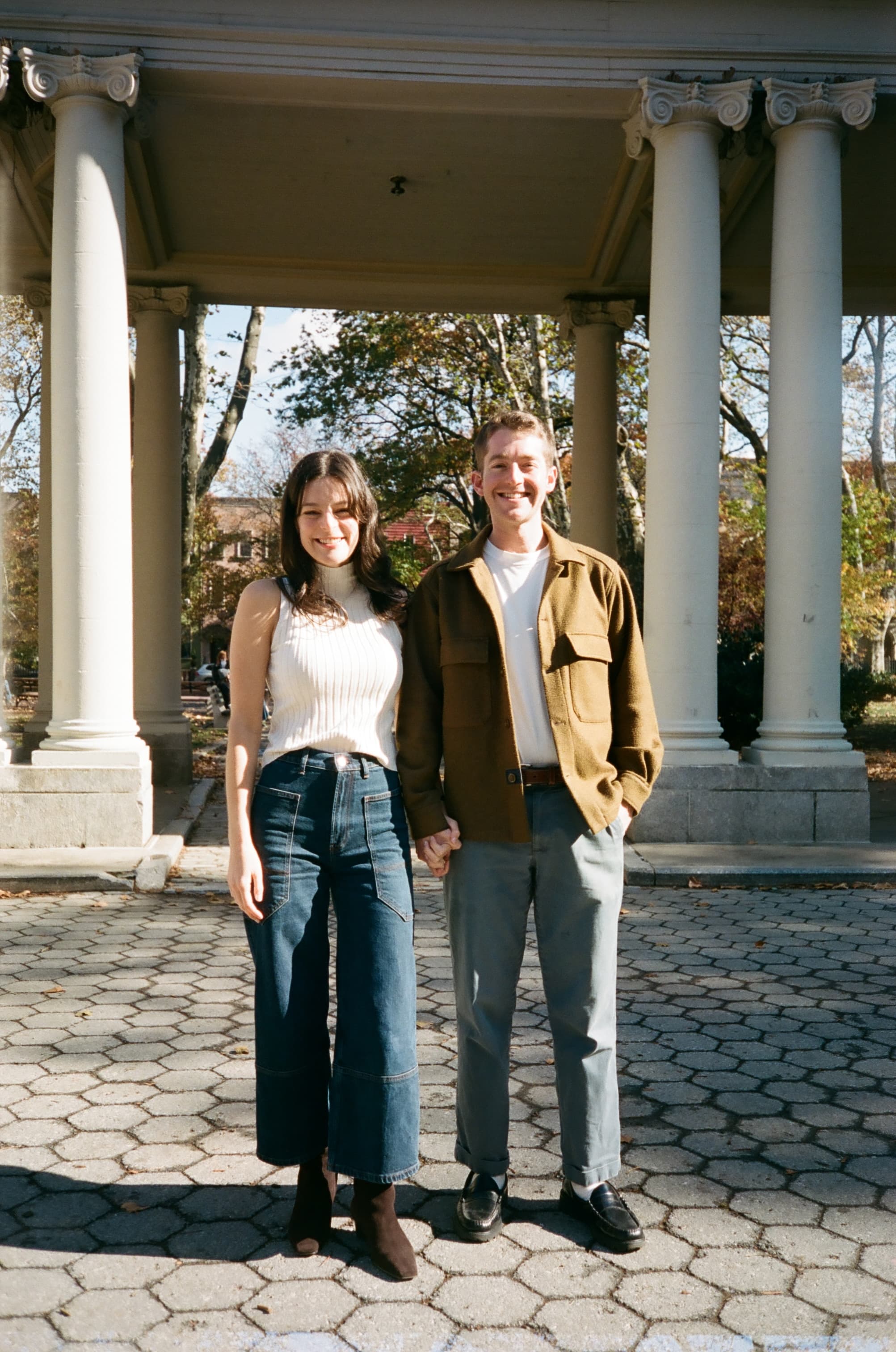 Emily and Will holding hands at the gazebo